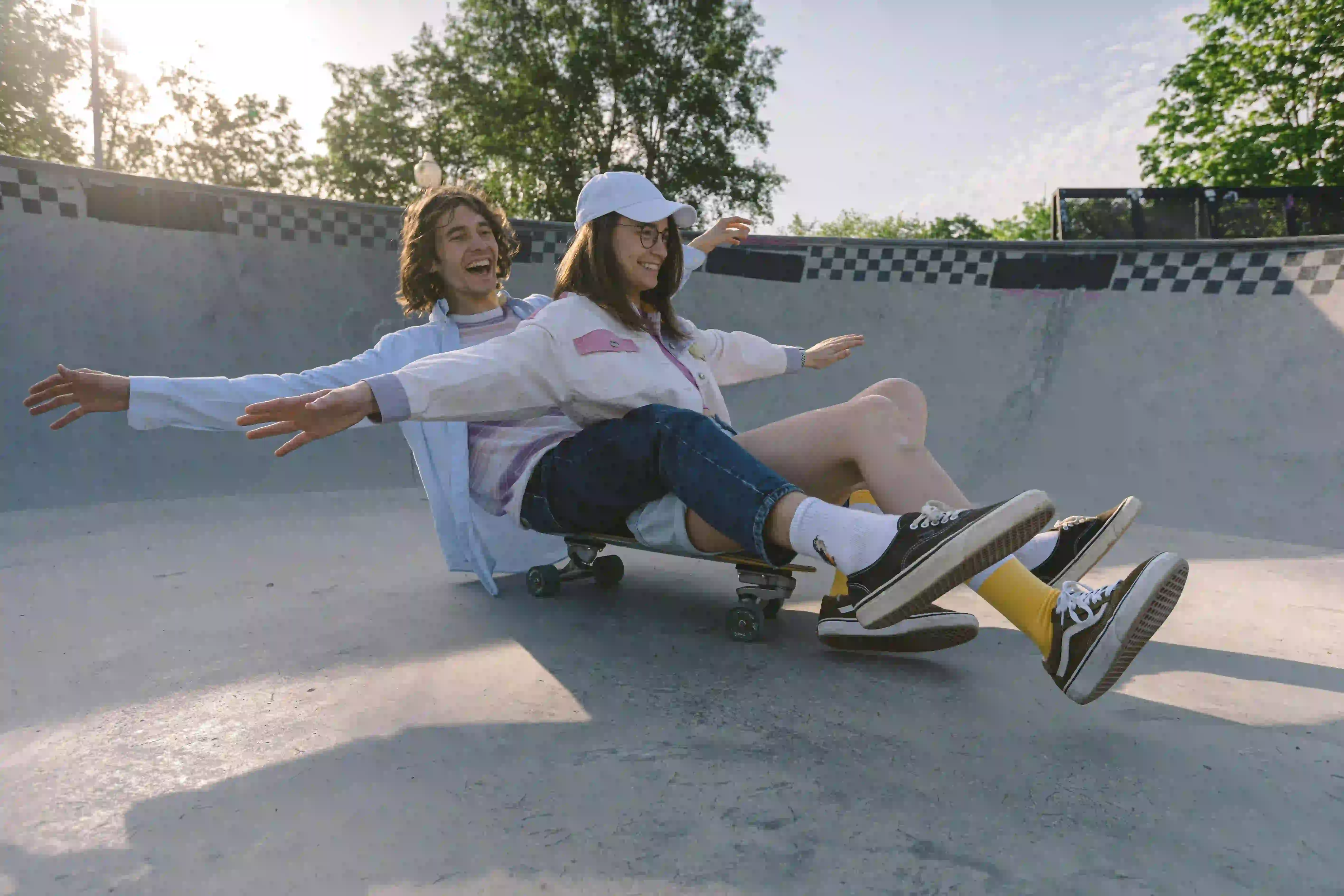 A man and a woman on a skateboard