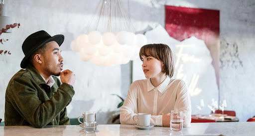 Couple conversing while waiting for their orders