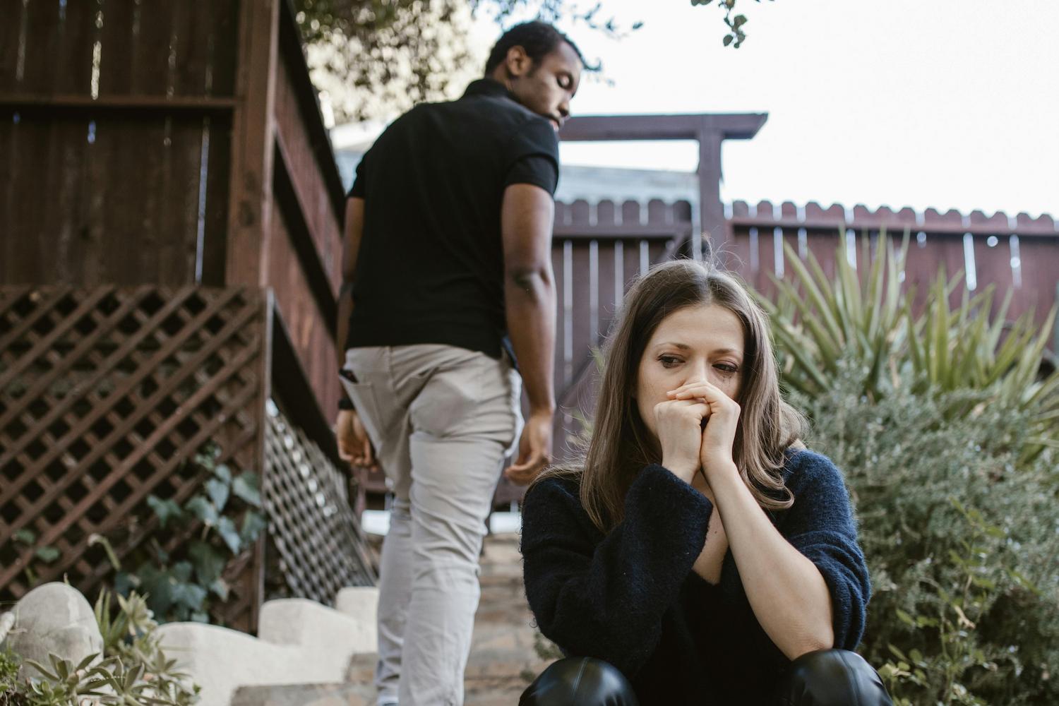 A man walking away after asking to break up with his partner