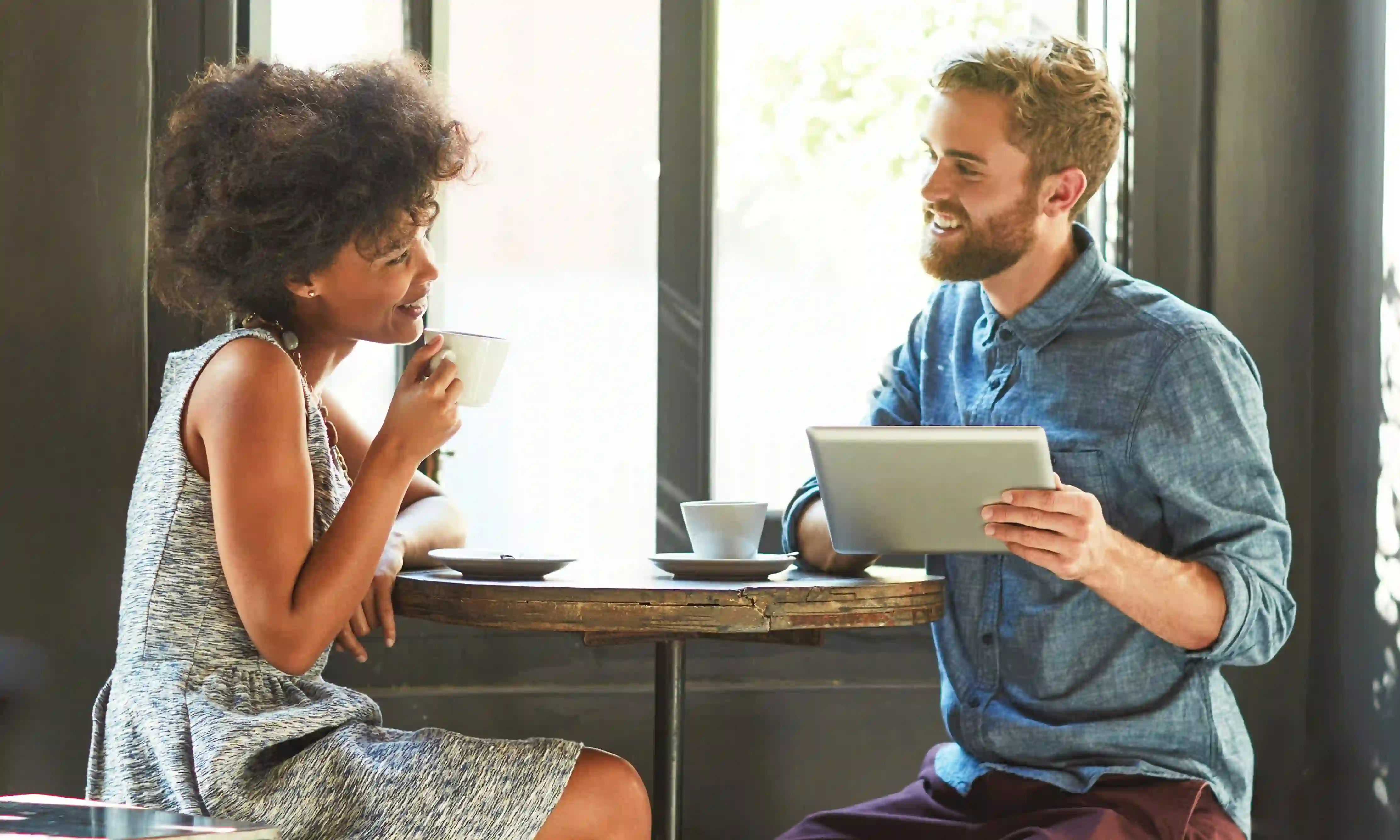 A man and a woman having coffee together