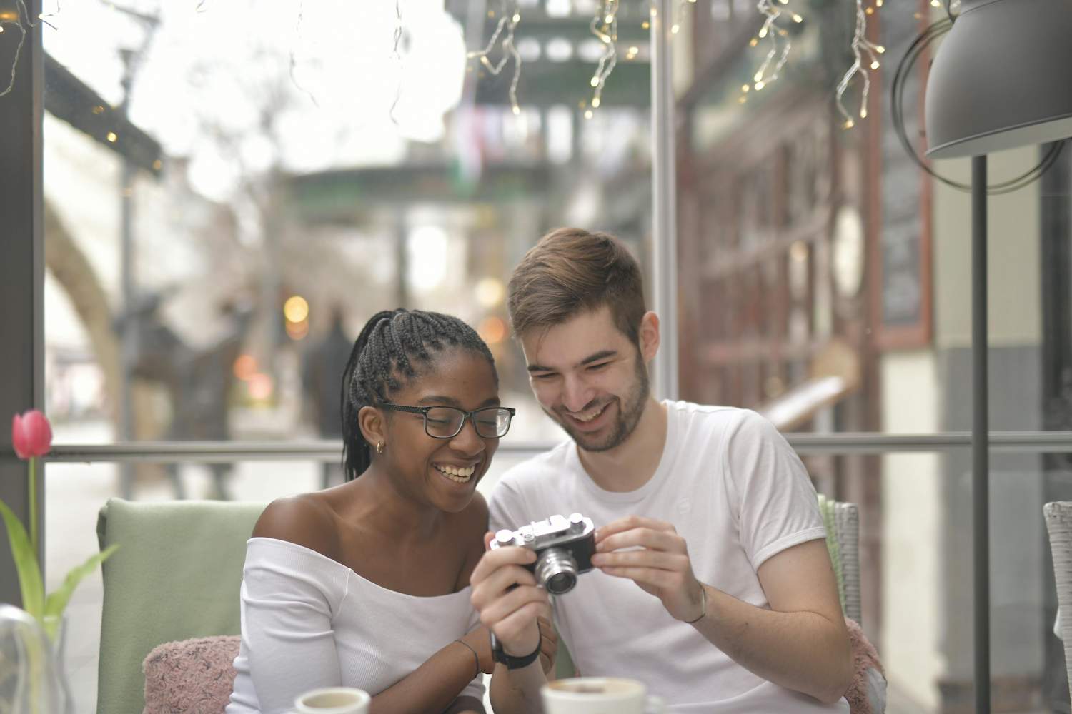 A couple smiling while looking at a camera together