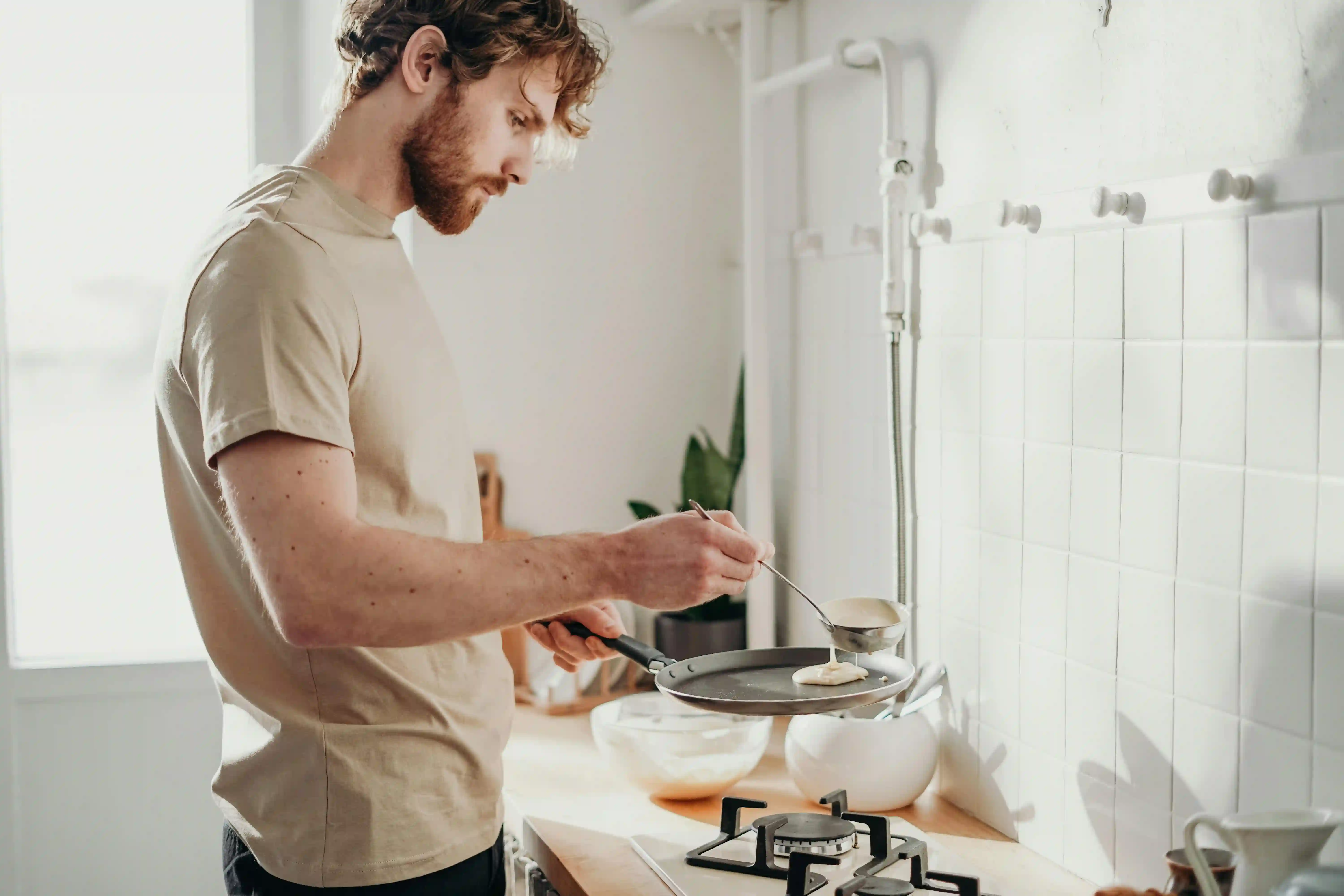 A man cooking pancakes