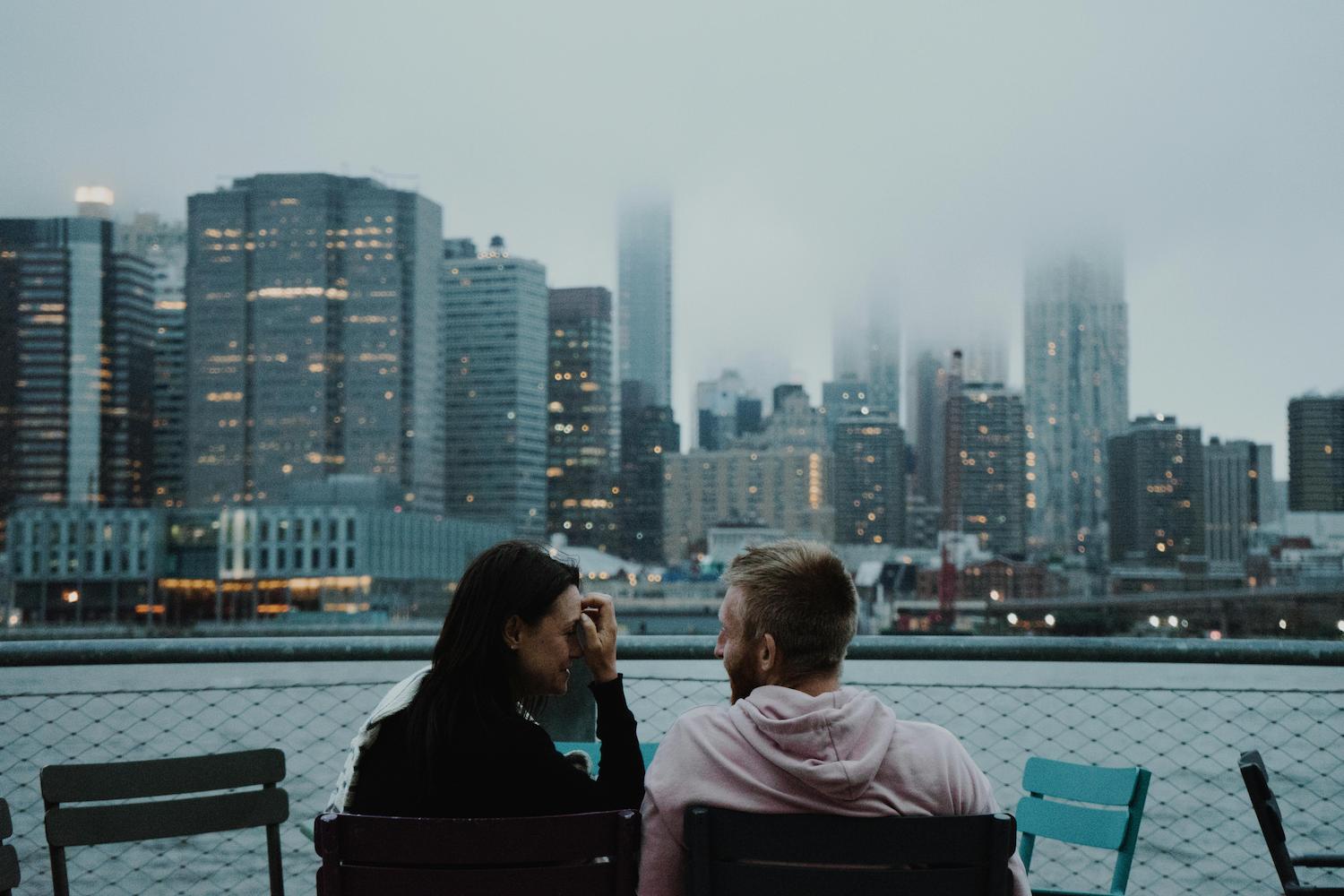 Man and woman talking on benches