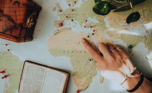 A finger pointing at a place in a map with pins placed on good places to visit are great topics to discuss with a girlfriend