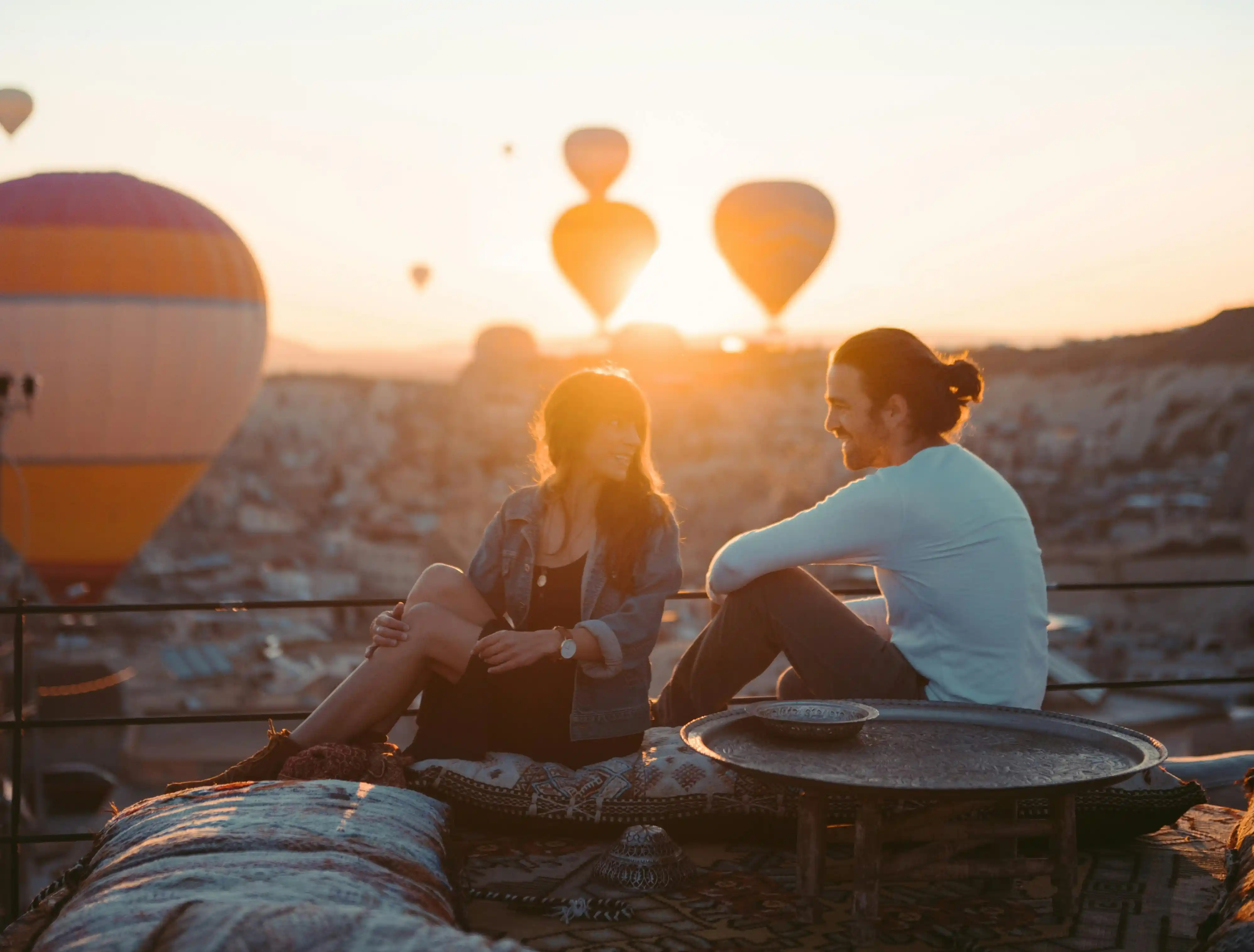 A couple overlooking hot air balloons is among memorable and unique date activities