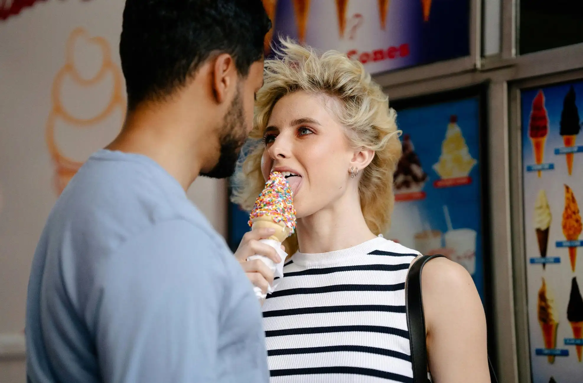 A man looking at his date eating ice cream while thinking “What do women want in a man?